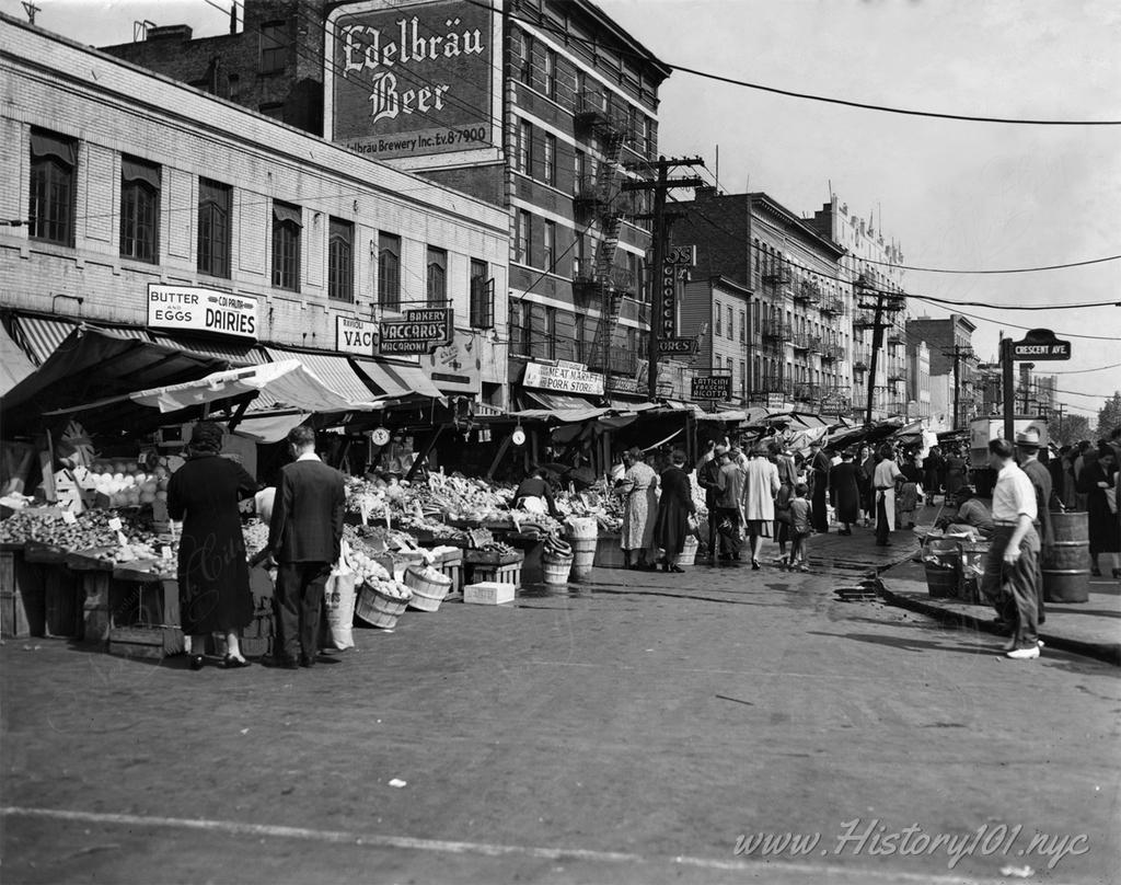 Photograph of a market of Italian push carts selling produce on Arthur & Crescent Avenues in the Bronx.