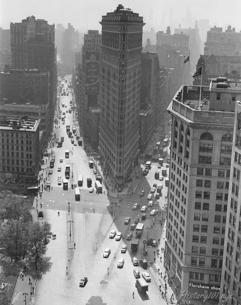 Photograph shows an aerial perspective of the Flatiron Building looking south from Madison Square.