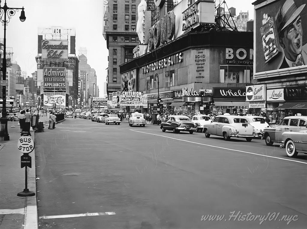 Photograph looking north at traffic along 7th Avenue facing Times Square with its many billboards and storefronts.