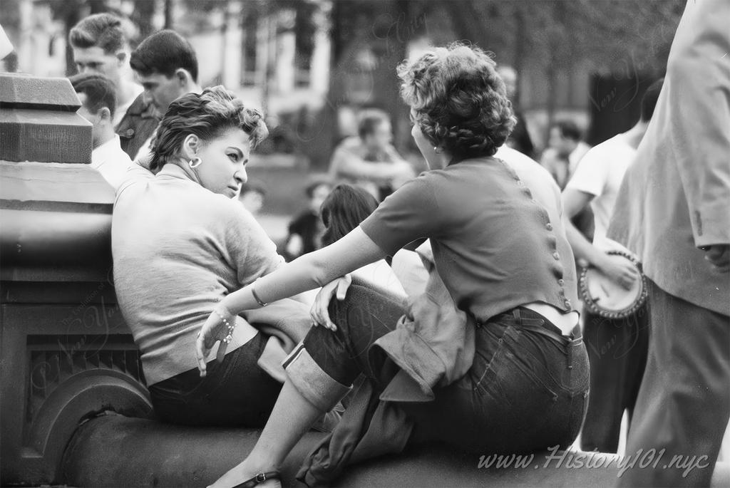 Photograph of two women sitting on the Fountain steps of Washington Square Park in Greenwich Village.