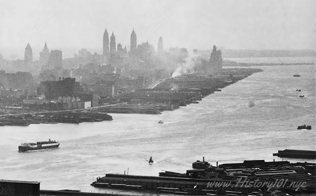 Photograph shows an aerial view of downtown Manhattan from across the East River.