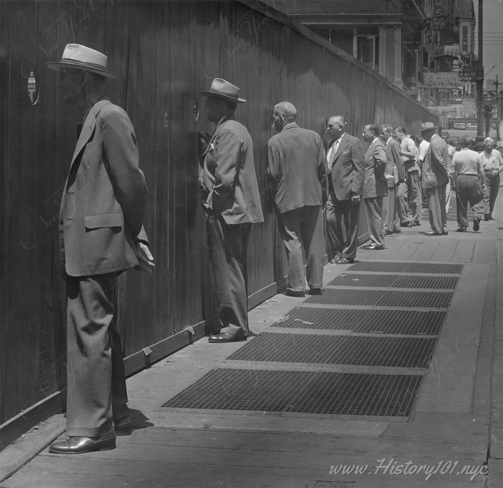 Angelo Rizzuto's 1949 photograph depicts NYC men curiously observing through holes, a testament to the city's vibrant street life