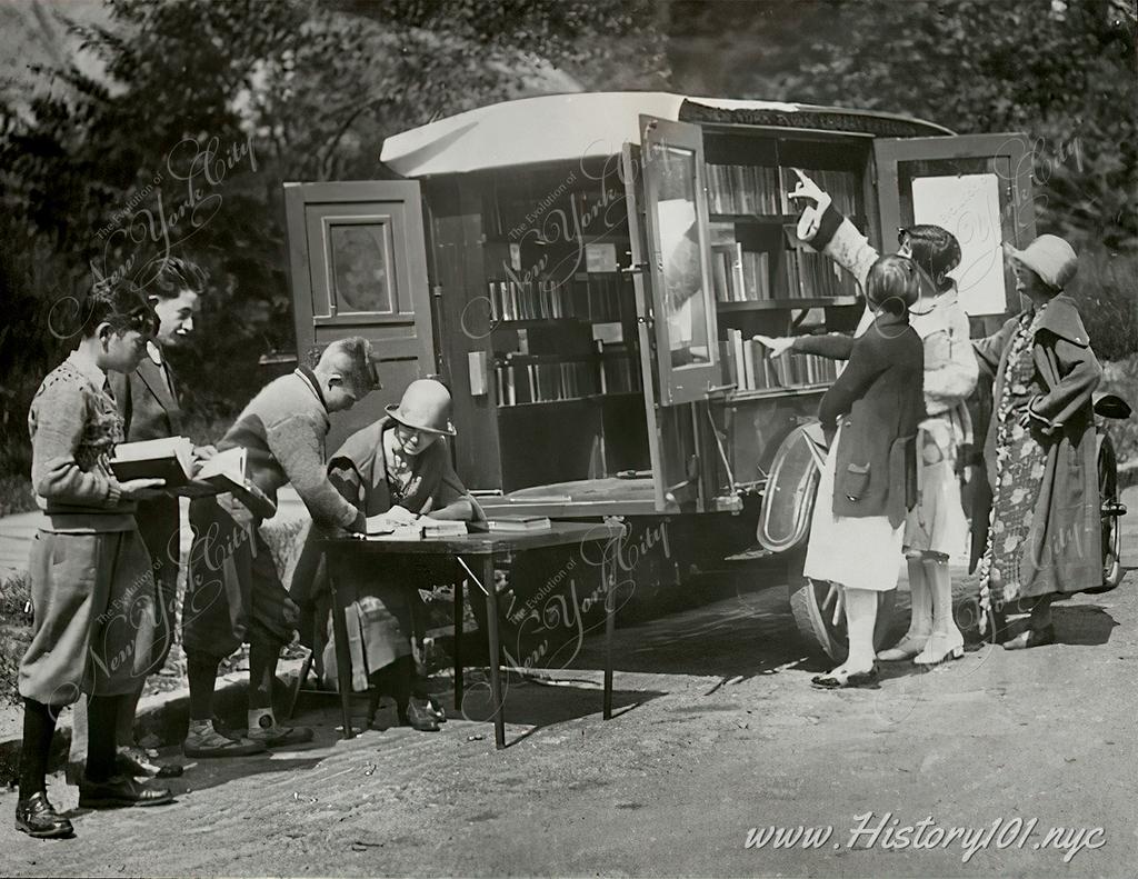 Photograph of readers choosing books from New York Public Library's bookmobile, known as  the Bronx Book Wagon.