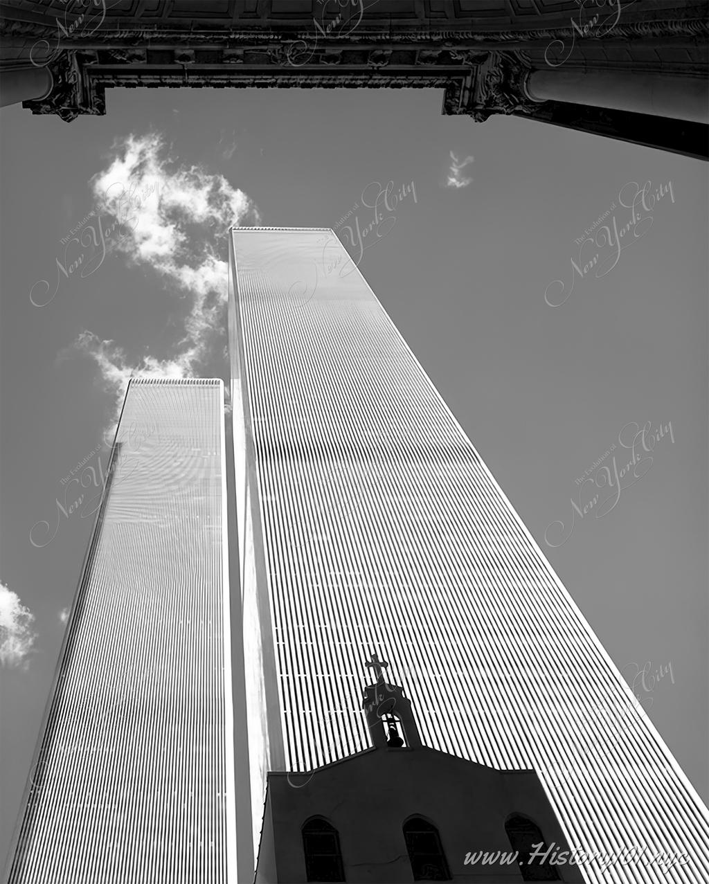 Photograph of the World Trade Center's Twin Towers with the silhouette of Saint Nicholas Orthodox Church in the foreground.