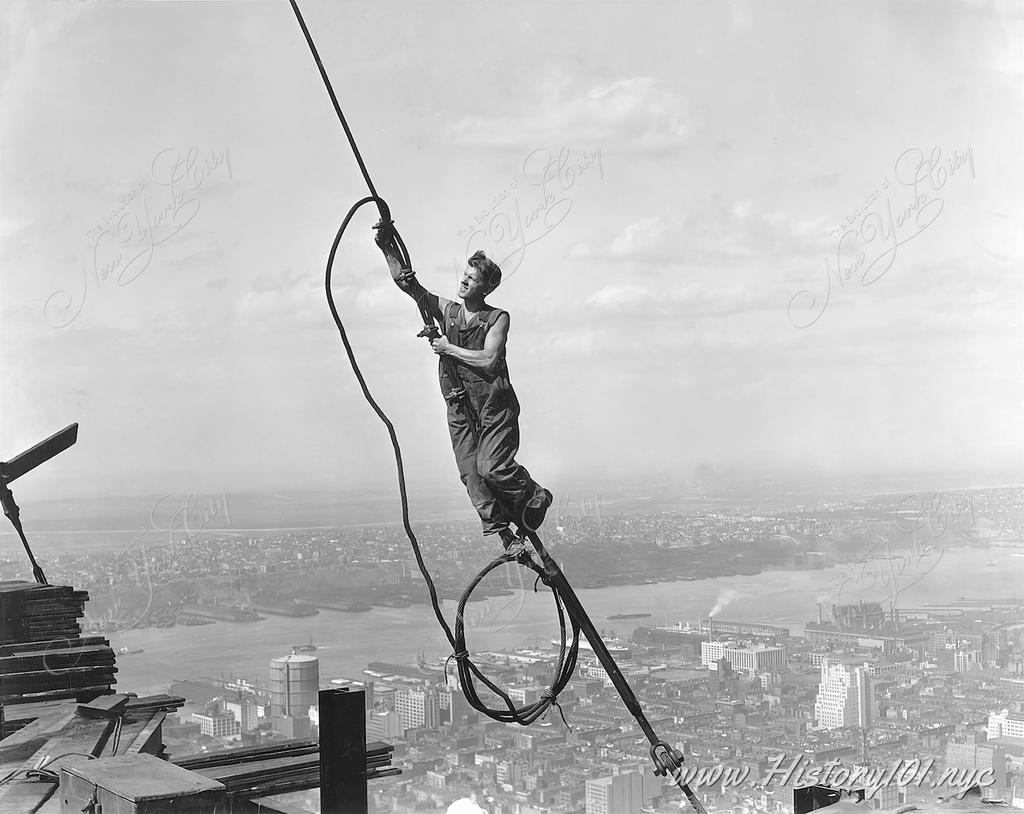 Stunning photograph of a daredevil construction worker at the Empire State Building, soaring above Manhattan like Icarus himself.