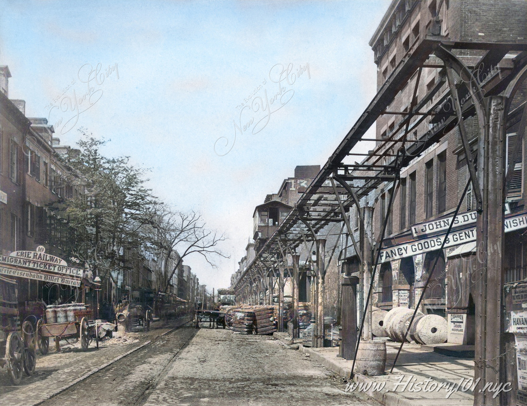 In the 1870s, Greenwich Street in New York City was a bustling hub of activity, with the Erie Railway Migrant Ticket Office and the elevated rail line adding to the vibrant atmosphere.