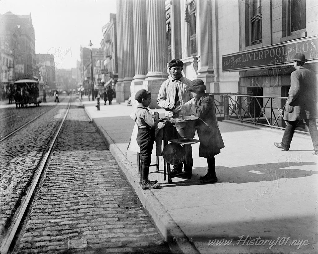 Children purchasing snacks from a street vendor on West 42nd Street.